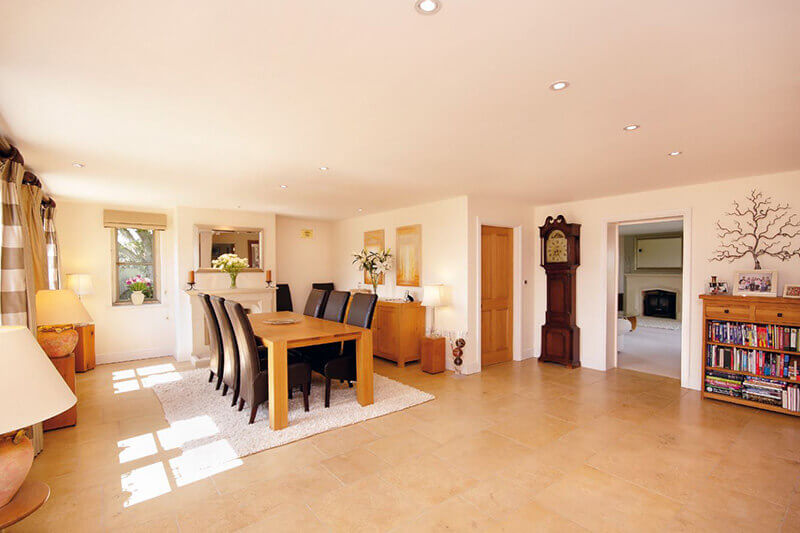 New natural stone floor laid to complement the style of house.