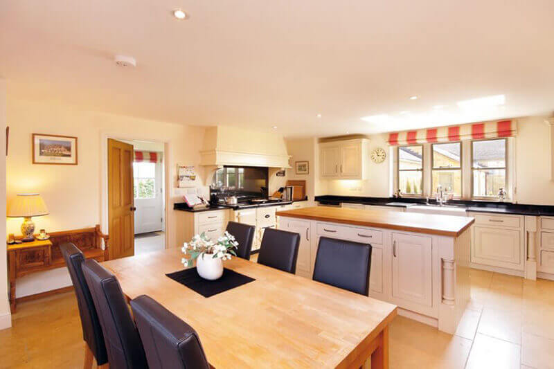 The kitchen/dining area was cleverly designed by the architect to create the heart of the home, achieving the client's dreams.