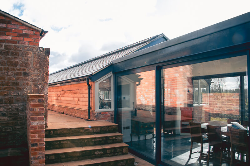 Bespoke design glass structure to link the existing house to the greenhouse.