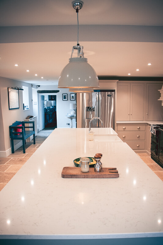 Harmonised areas between kitchen and dining room with sawn and tumbled limestone throughout.