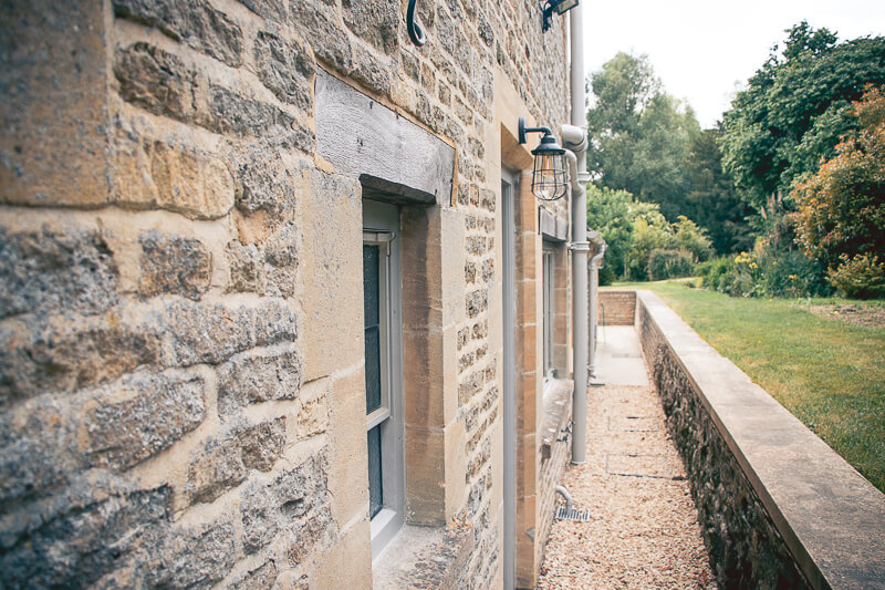 Doorways and windows were added to this elevation. Re-pointing using traditional lime mortar was carried out throughout to match the existing walls.

