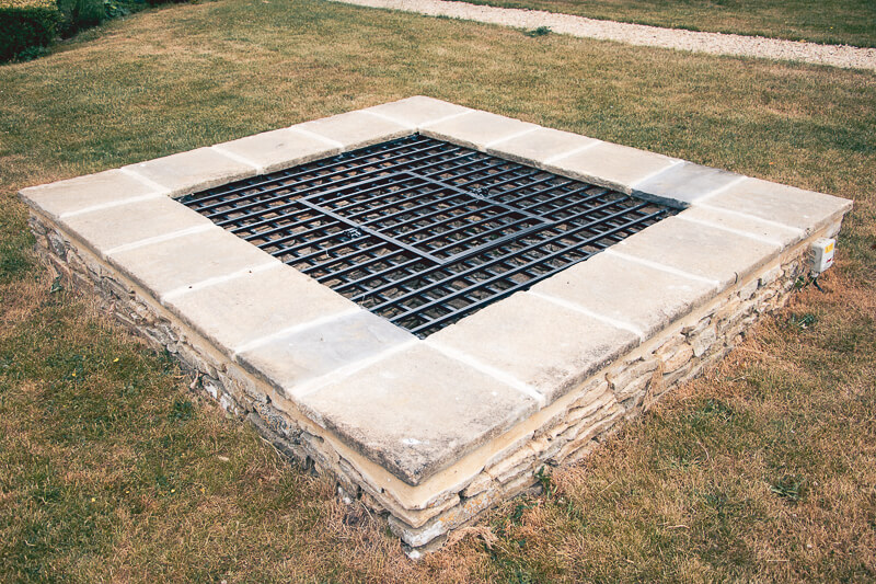 This drainage well, was made into a feature. Previously made of timber decking, this was removed and replaced with a wrought iron grate carried by re-capped low walls.