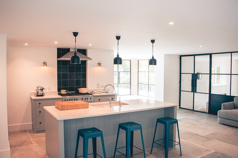 Granite worktops enhance the clean lines of the Shaker units. Mood lighting installed by our electricians; limestone floors cleaned and re-laid. Internal lattice casement windows were installed to allow for a bright and airy kitchen/dining area. 