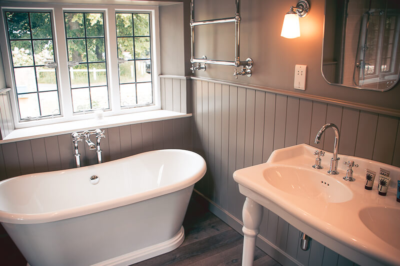 Traditional style new bathroom was installed and placed in a new design layout. All wood panelling was bespoke and made by our joinery company.